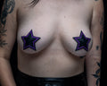 Black leather star pasties with purple glitter outline worn on a tattooed model