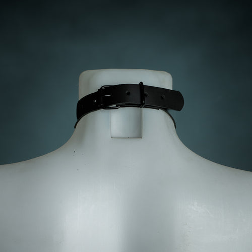 Back view of the black leather O-ring choker showing the black buckle closure and size holes, by Wandering Chaos