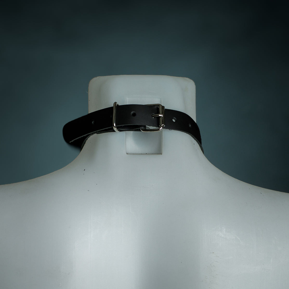 Back view of the black leather O-ring choker showing the silver buckle closure and size holes, by Wandering Chaos