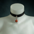 Samhain black leather choker with an orange jack-o'-lantern bell on a silver O-ring, Halloween Exclusive by Wandering Chaos